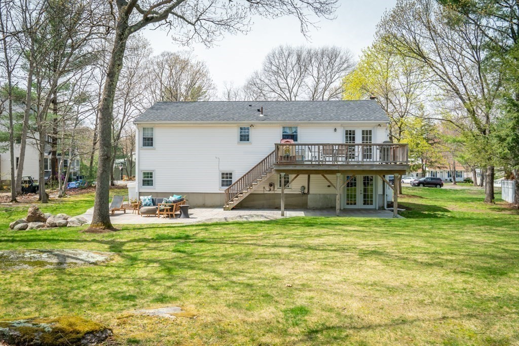 7 Geraldine Lane Braintree, MA 02184 - Photo 24 of 26 a view of a house with a big yard and large trees