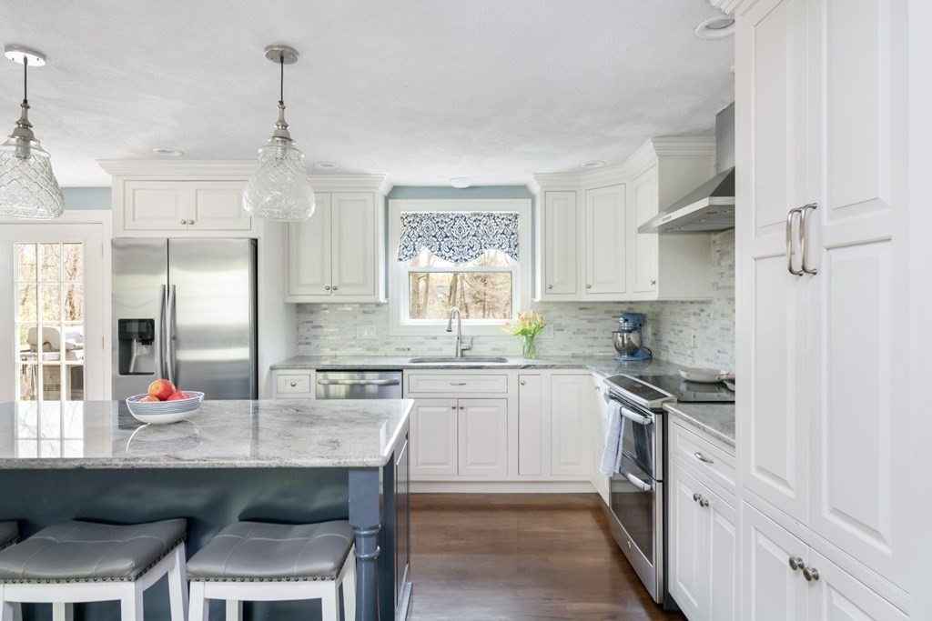 7 Geraldine Lane Braintree, MA 02184 - Photo 3 of 26 a kitchen with stainless steel appliances granite countertop a stove a sink dishwasher a refrigerator with white cabinets and wooden floor