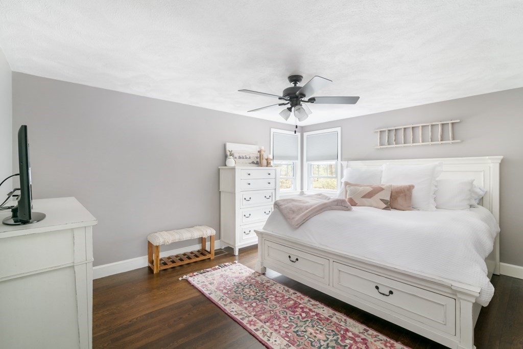7 Geraldine Lane Braintree, MA 02184 - Photo 9 of 26 a bedroom with a bed and a chandelier
