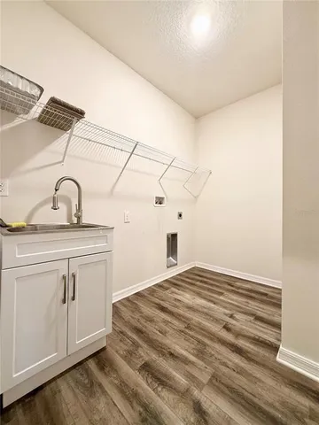 a view of a kitchen sink with wooden floor
