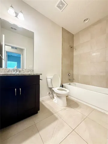 a bathroom with a bathtub sink mirror and toilet