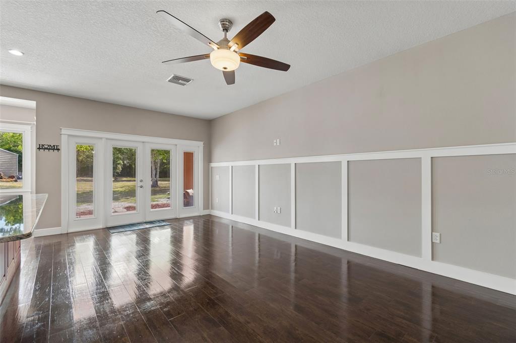 29913 Darby Road Dade City, FL 33525 - Photo 15 of 100 a view of an empty room with wooden floor and a window