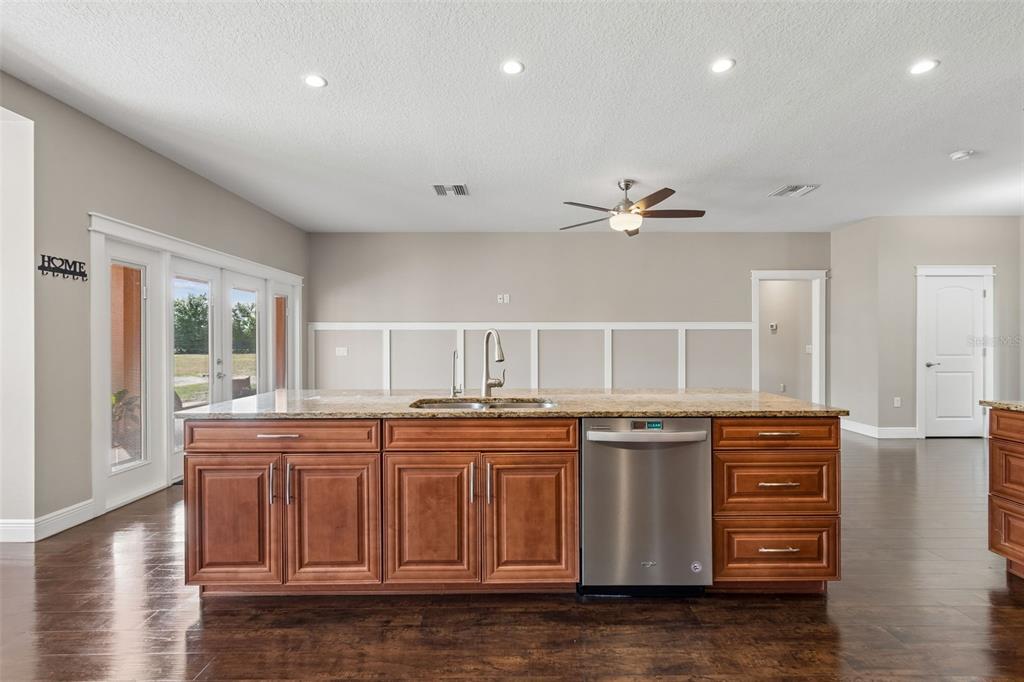 29913 Darby Road Dade City, FL 33525 - Photo 22 of 100 a kitchen with stainless steel appliances granite countertop a sink and wooden cabinets