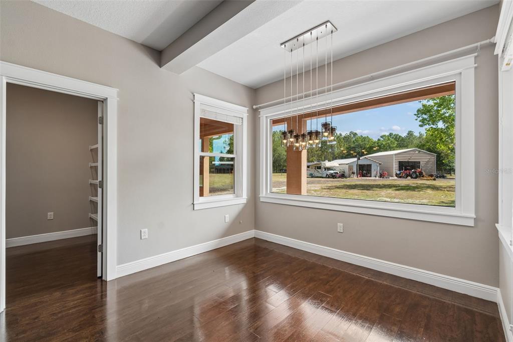 29913 Darby Road Dade City, FL 33525 - Photo 24 of 100 an empty room with wooden floor and windows