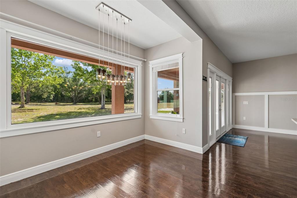 29913 Darby Road Dade City, FL 33525 - Photo 27 of 100 a view of an empty room with wooden floor and a window