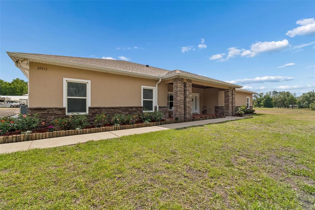 29913 Darby Road Dade City, FL 33525 - Photo 3 of 100 a front view of house with yard and green space