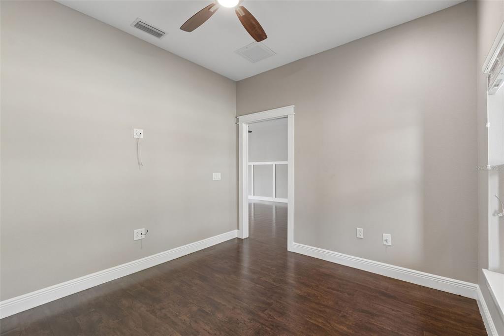 29913 Darby Road Dade City, FL 33525 - Photo 36 of 100 an empty room with wooden floor and natural light