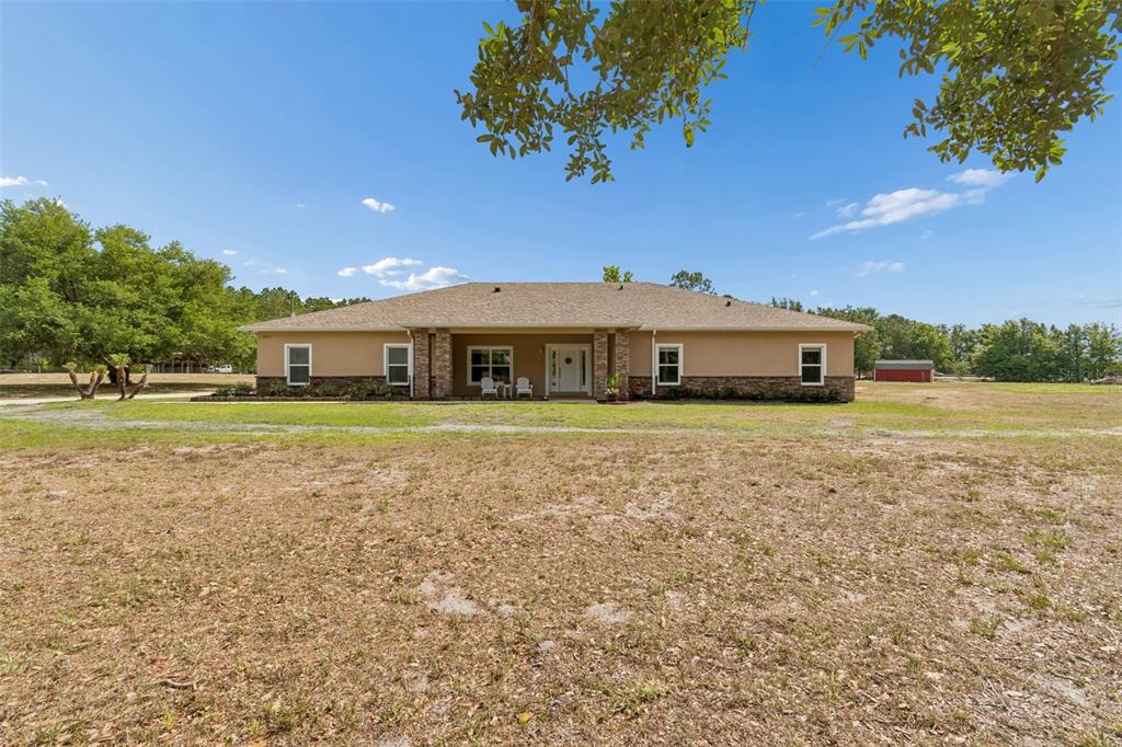29913 Darby Road Dade City, FL 33525 - Photo 4 of 100 a front view of a house with a garden