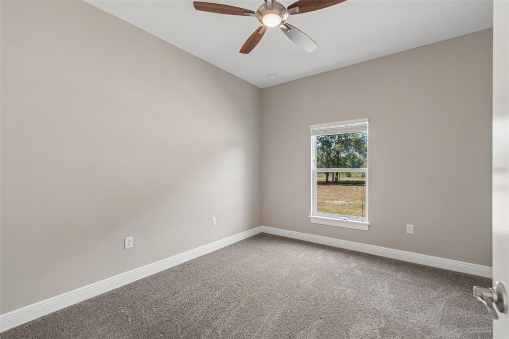 29913 Darby Road Dade City, FL 33525 - Photo 41 of 100 an empty room with a window and a fan