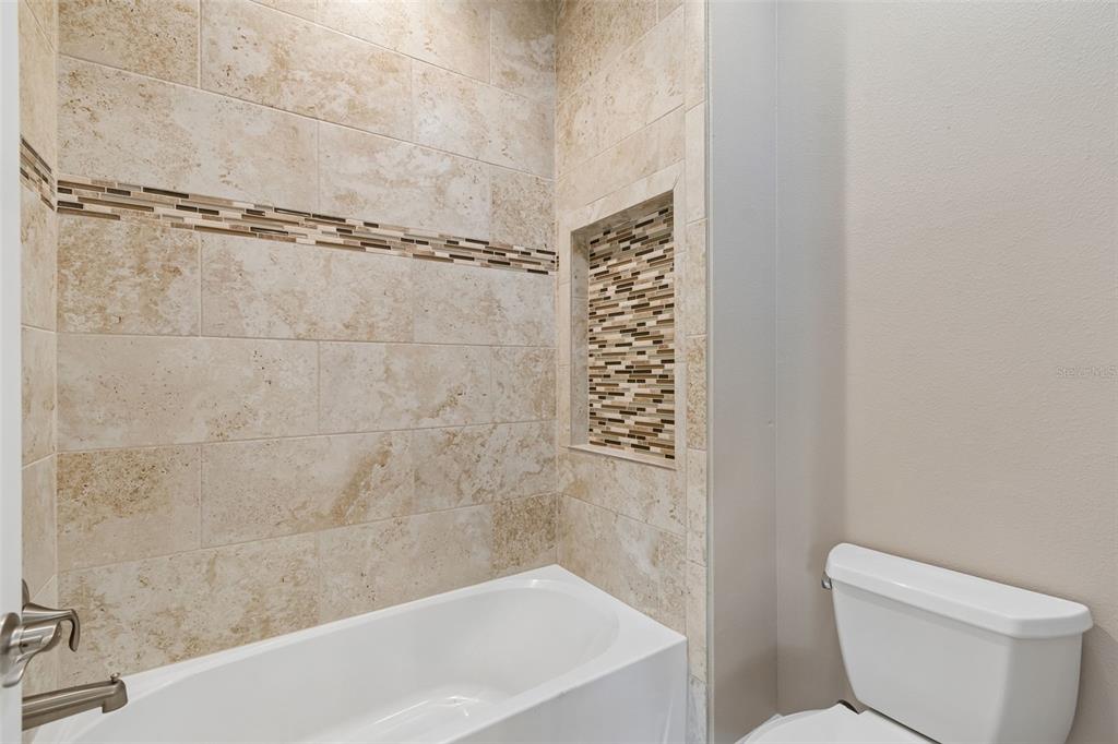 29913 Darby Road Dade City, FL 33525 - Photo 47 of 100 a bathroom with a shower and a toilet