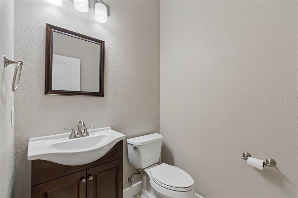 29913 Darby Road Dade City, FL 33525 - Photo 52 of 100 a bathroom with a toilet a sink and mirror