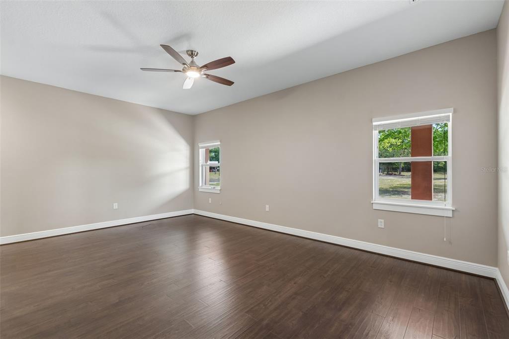 29913 Darby Road Dade City, FL 33525 - Photo 57 of 100 an empty room with wooden floor fan and windows