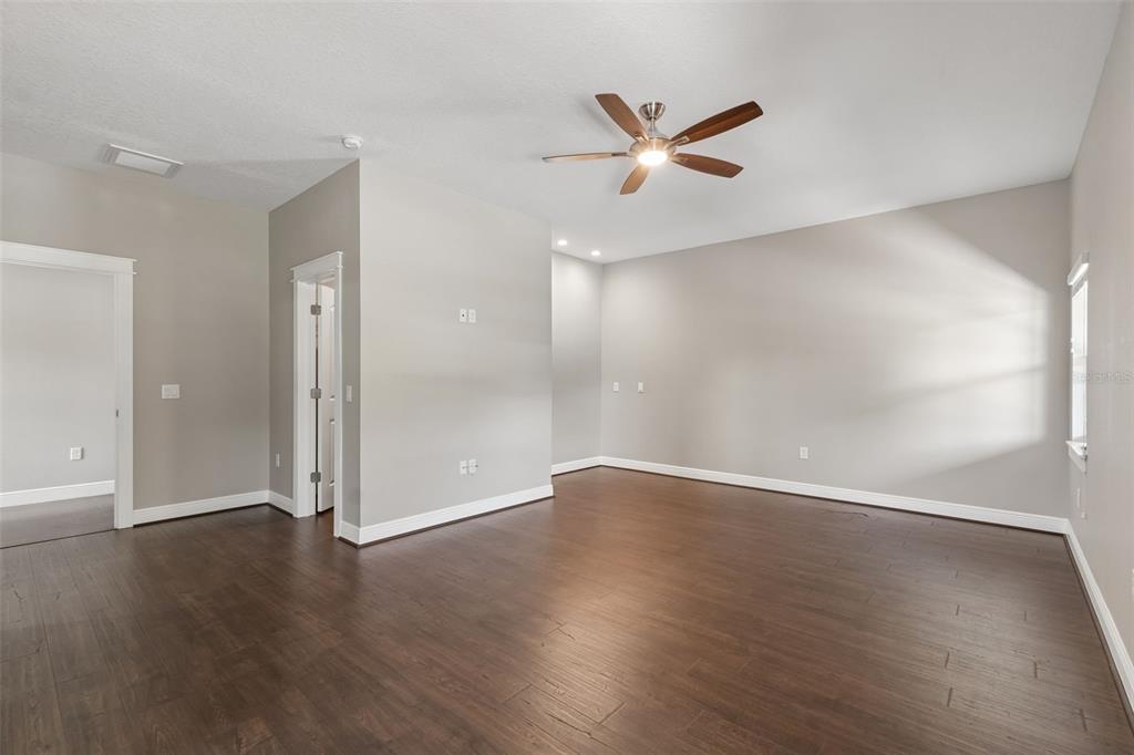 29913 Darby Road Dade City, FL 33525 - Photo 58 of 100 an empty room with wooden floor and windows
