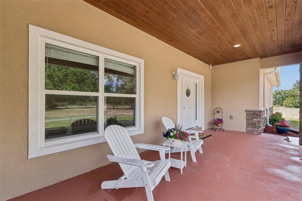 29913 Darby Road Dade City, FL 33525 - Photo 6 of 100 a living room with furniture a table and a large window