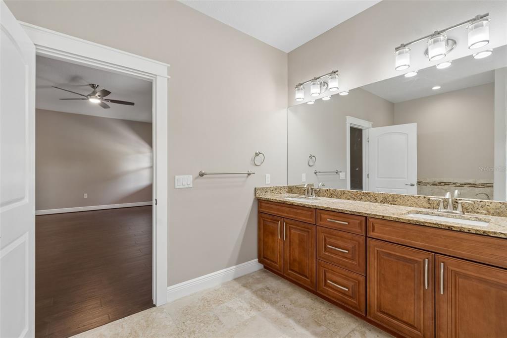 29913 Darby Road Dade City, FL 33525 - Photo 63 of 100 a spacious bathroom with a double vanity sink and a mirror