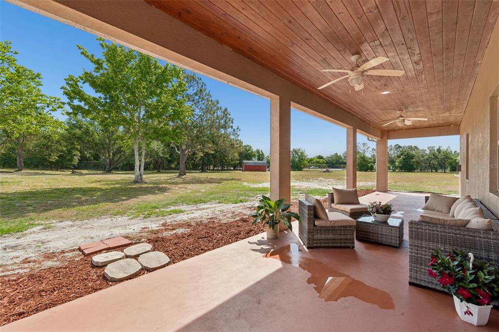29913 Darby Road Dade City, FL 33525 - Photo 74 of 100 a living room with patio furniture and a big yard