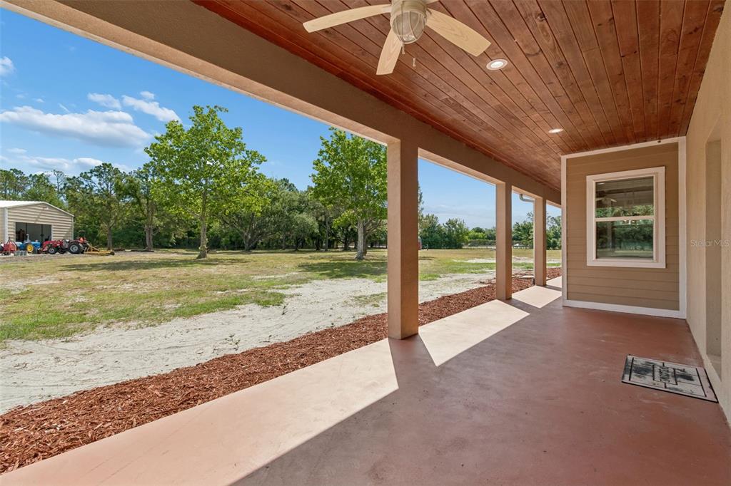 29913 Darby Road Dade City, FL 33525 - Photo 82 of 100 a view of a house with backyard and porch