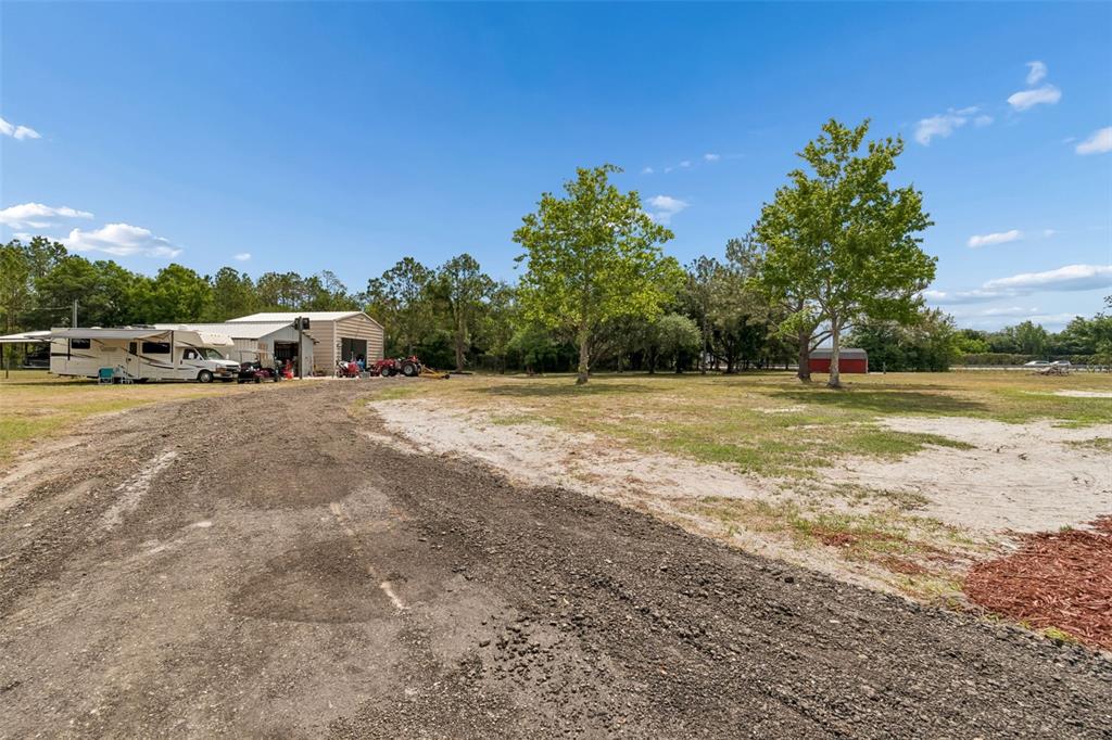 29913 Darby Road Dade City, FL 33525 - Photo 86 of 100 a view of a swimming pool and trees in the background