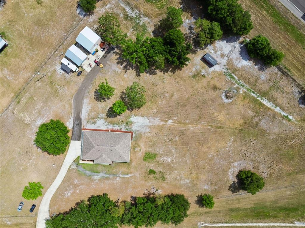 29913 Darby Road Dade City, FL 33525 - Photo 95 of 100 an aerial view of a house with a yard and a garage