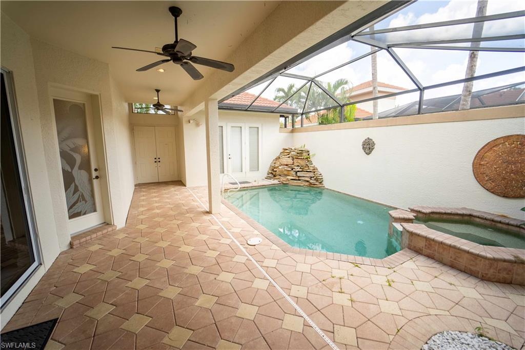 5886 Paradise Circle Naples, FL 34110 - Photo 3 of 19 View of swimming pool with an in ground hot tub, a lanai, ceiling fan, and a patio area