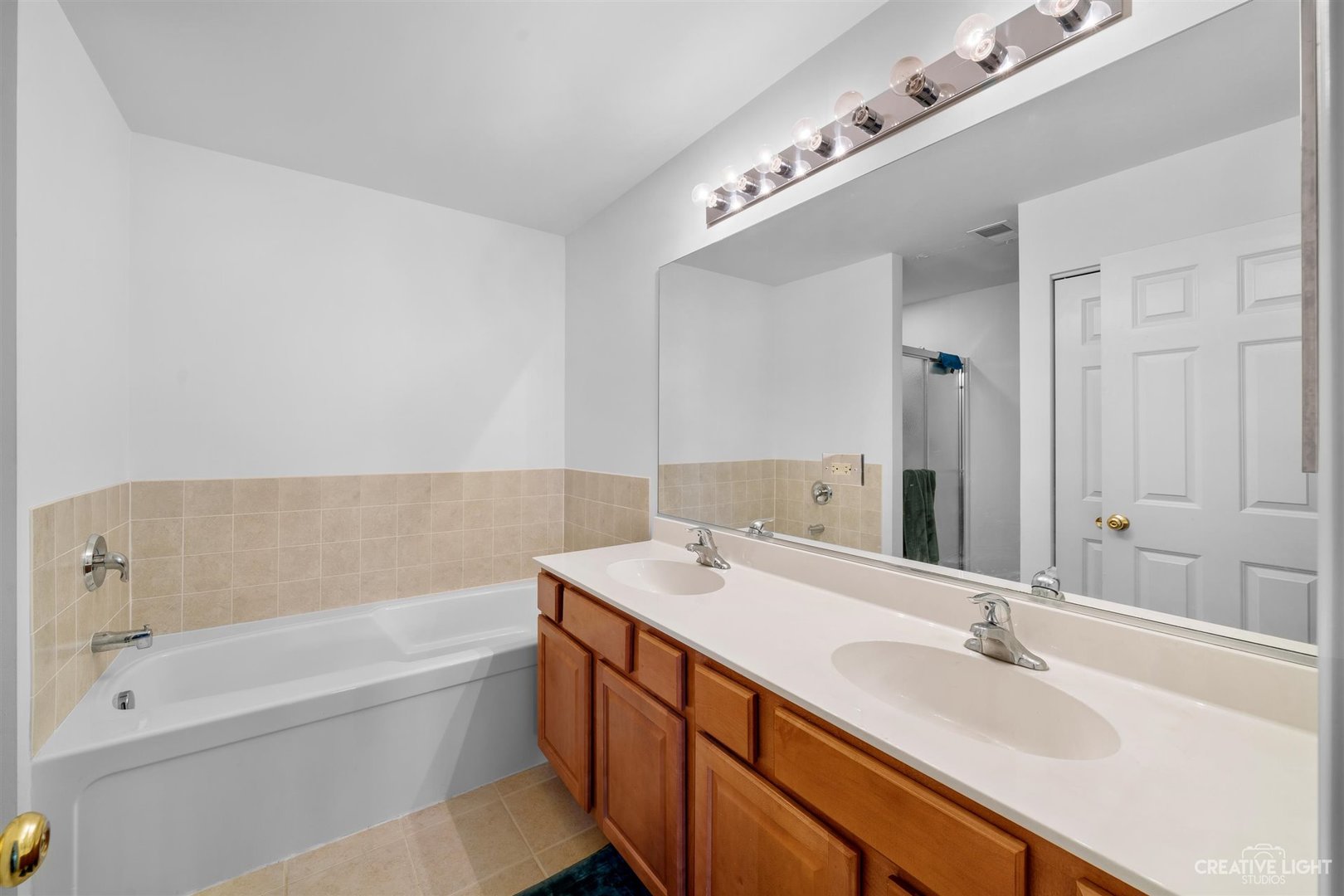 176b Brompton Lane, Unit A Sugar Grove, IL 60554 - Photo 12 of 17 a bathroom with a tub double sink and mirror
