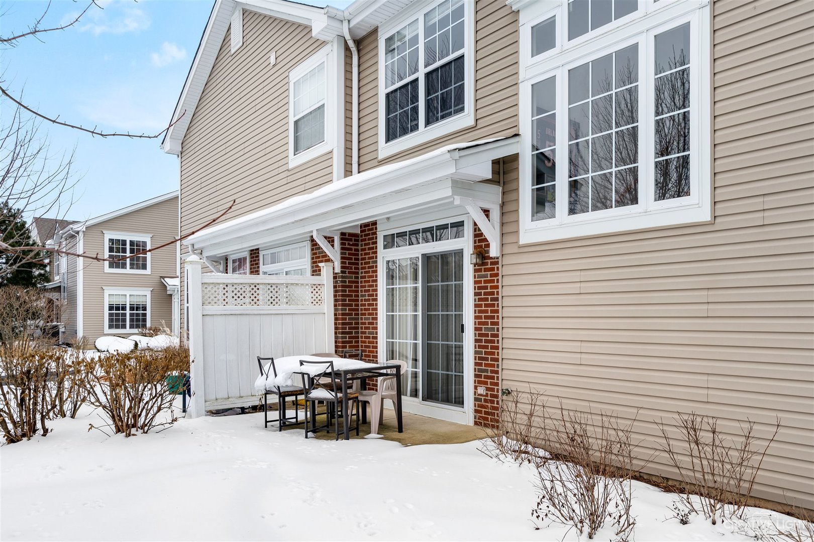 176b Brompton Lane, Unit A Sugar Grove, IL 60554 - Photo 17 of 17 a view of a patio with a table and chairs and floor to ceiling window