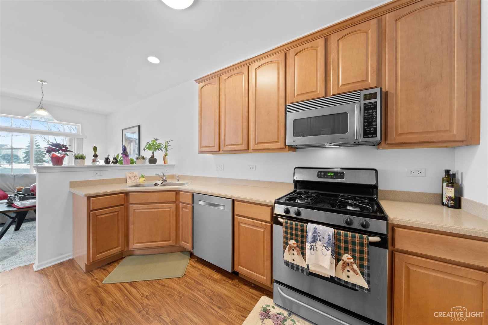 176b Brompton Lane, Unit A Sugar Grove, IL 60554 - Photo 8 of 17 a kitchen with stainless steel appliances granite countertop a stove a sink and a microwave