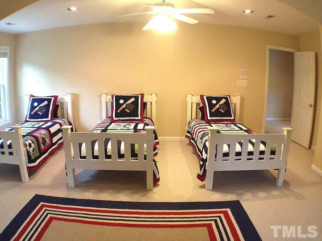 a bedroom with two beds and a chandelier