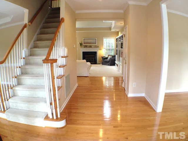 a view of entryway and hall with wooden floor