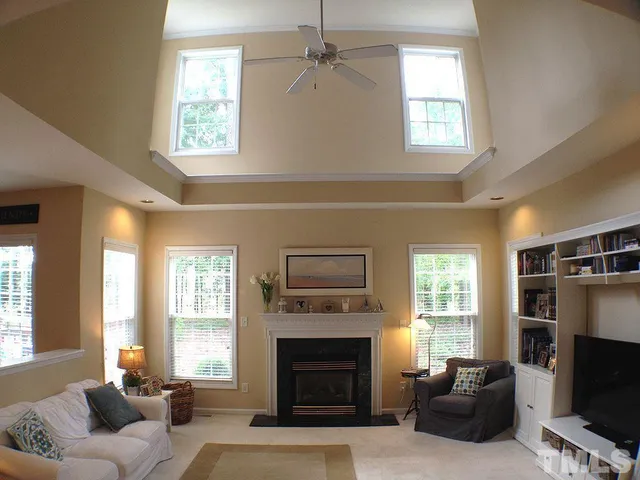 a living room with furniture a window and a fireplace