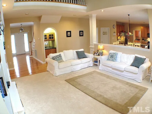a living room with furniture and a large mirror