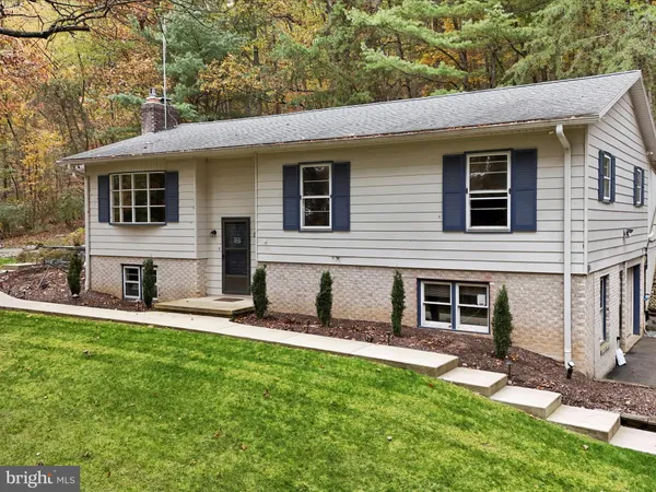 a view of a house with a yard in front of it