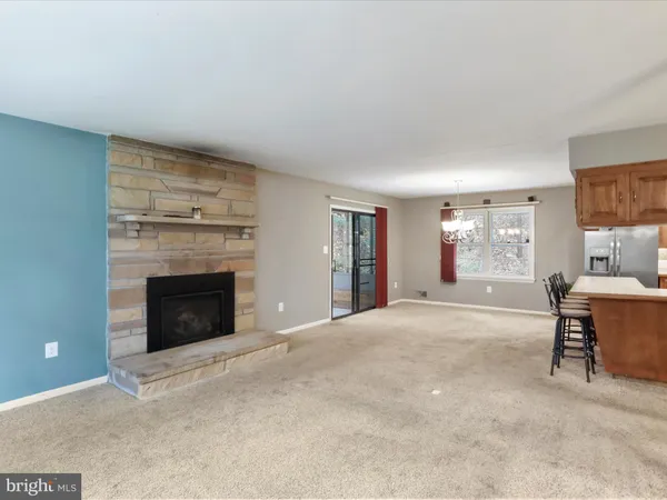 a living room with furniture a fireplace and a window