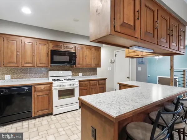 a kitchen with stainless steel appliances granite countertop a stove refrigerator sink and cabinets