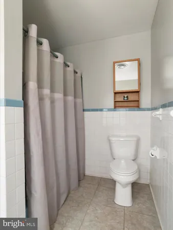 an empty room with a window and a ceiling fan