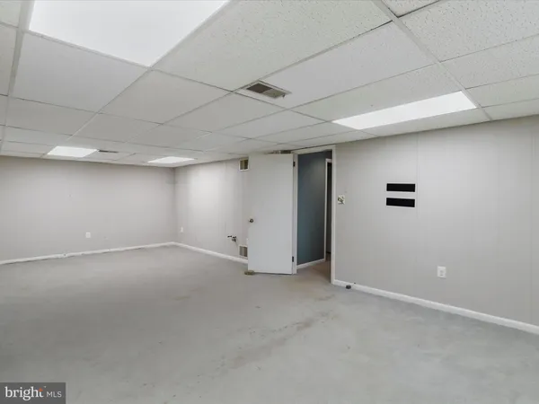 a view of empty room with wooden walls