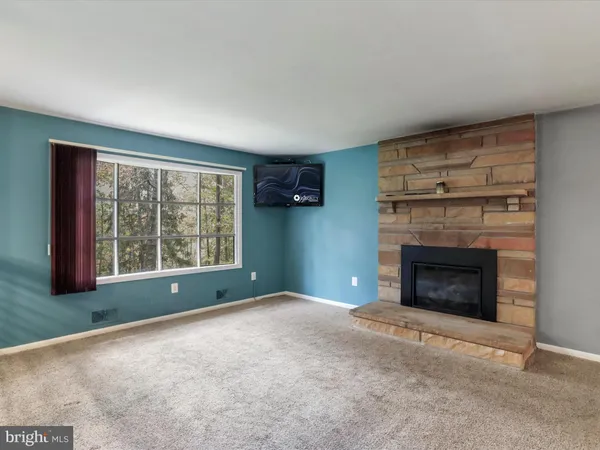 a view of empty room with a fireplace