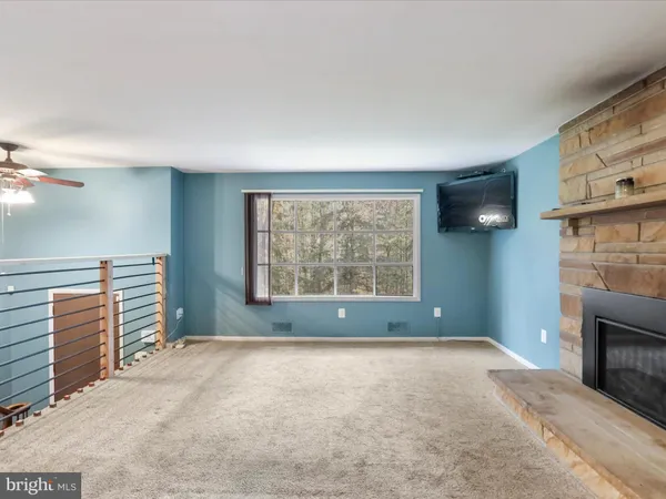 a view of empty room with a fireplace