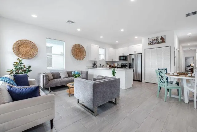 a living room with furniture kitchen and a table
