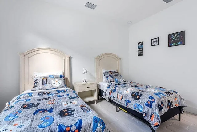 a bedroom with two beds and a window