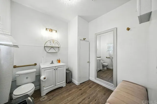 a bathroom with a toilet a sink and a mirror