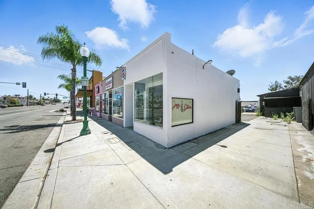 a building exterior with furniture and garden