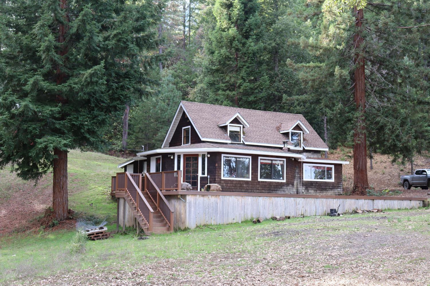aerial view of a house with a yard and deck