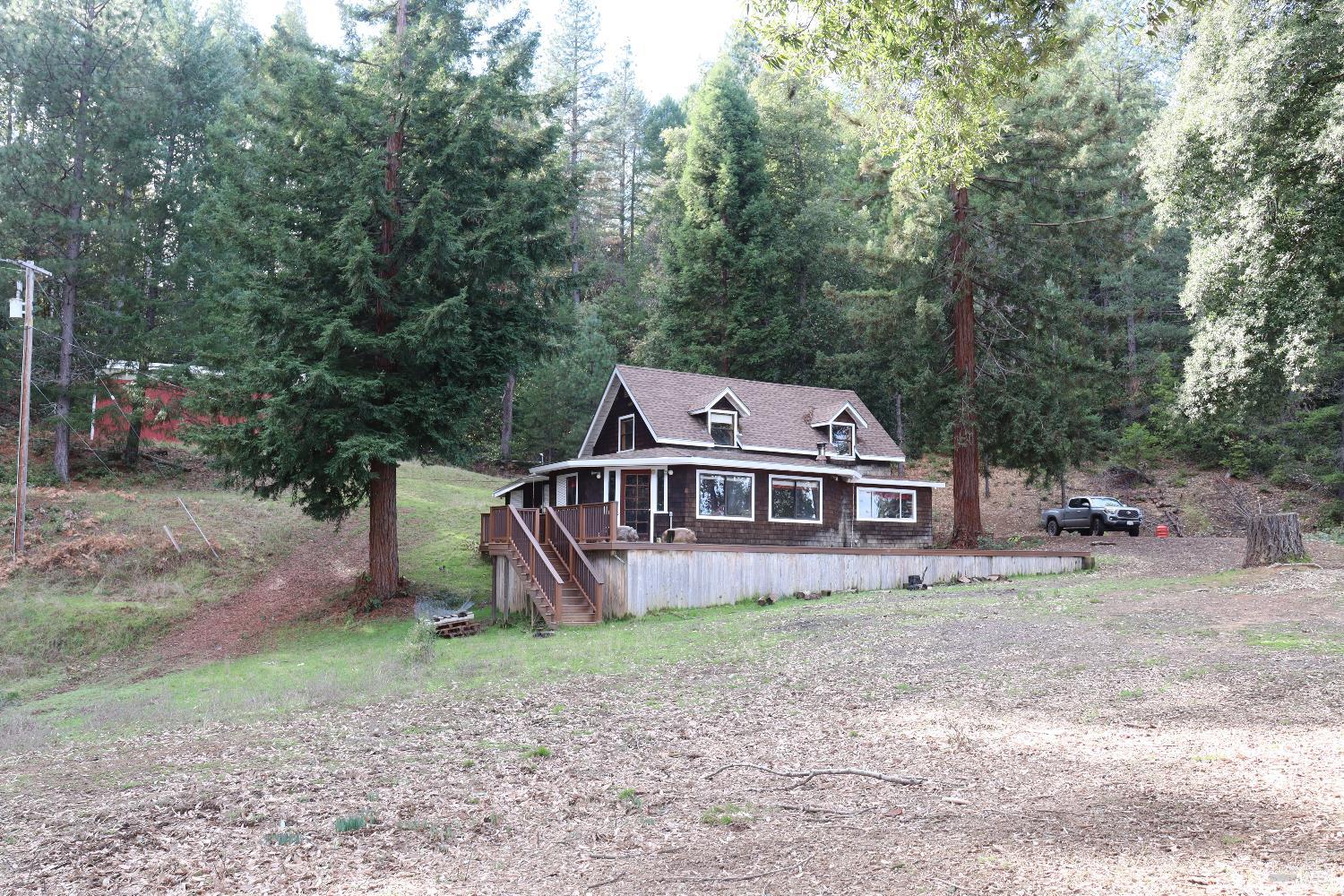 7020 Hearst Road Willits, CA 95490 - Photo 2 of 13 an aerial view of a house with a yard and a tree