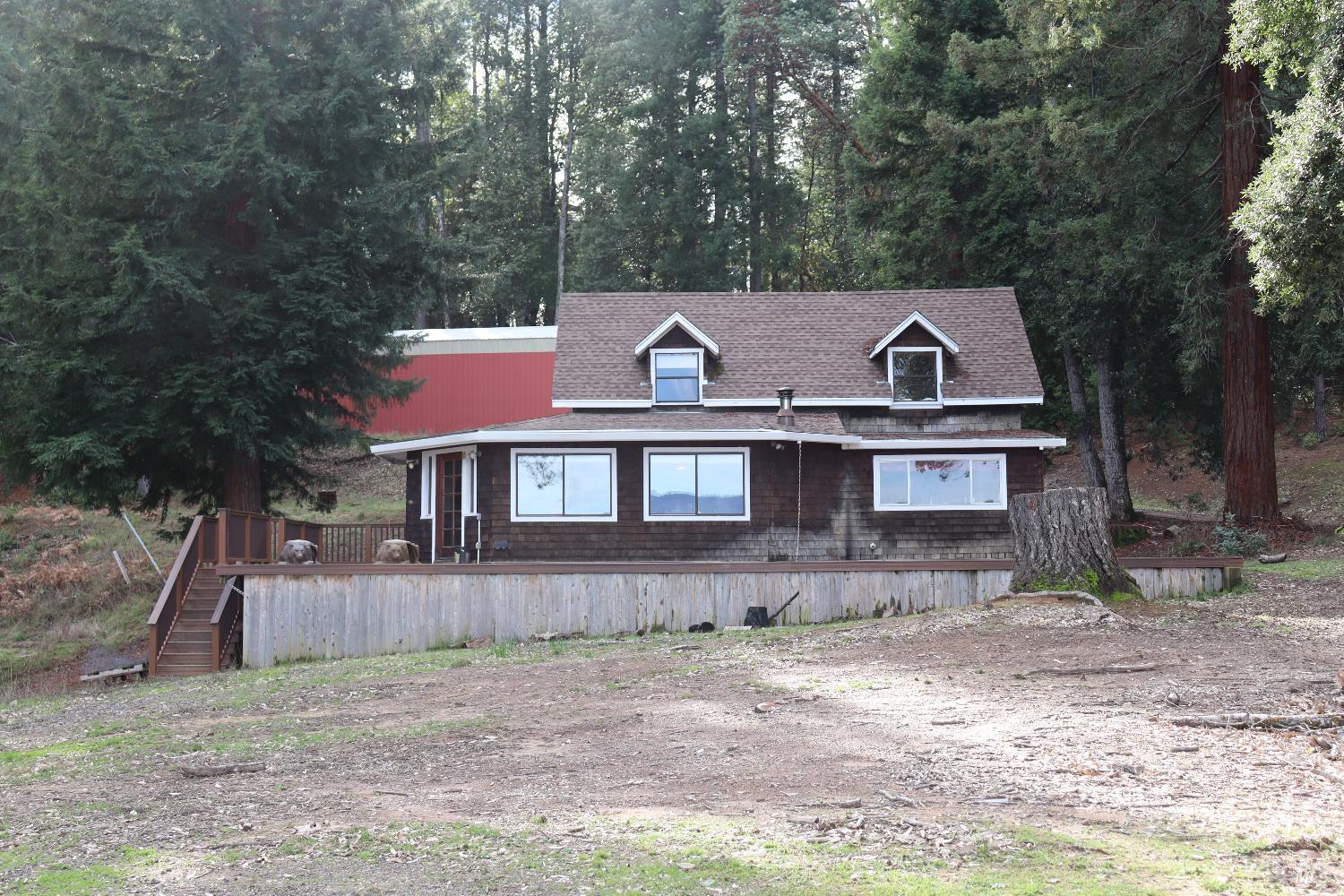 7020 Hearst Road Willits, CA 95490 - Photo 9 of 13 a front view of a house with garden