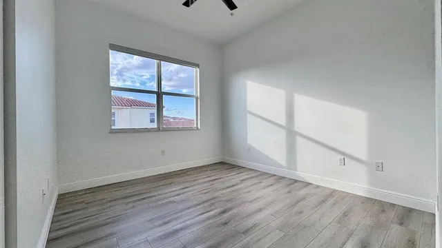a bedroom with bed and a window
