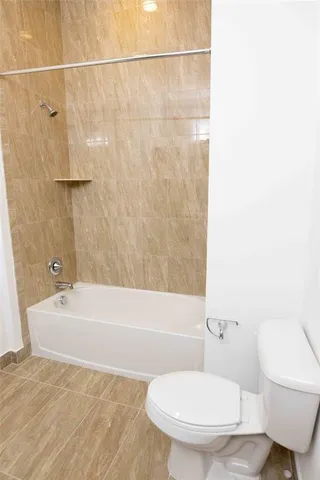 a bathroom with a bathtub and shower