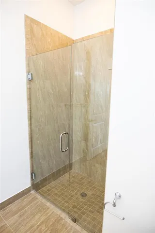 a bathroom with a toilet and a shower