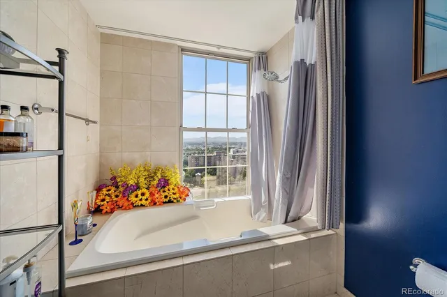 a bathroom with a sink mirror and window
