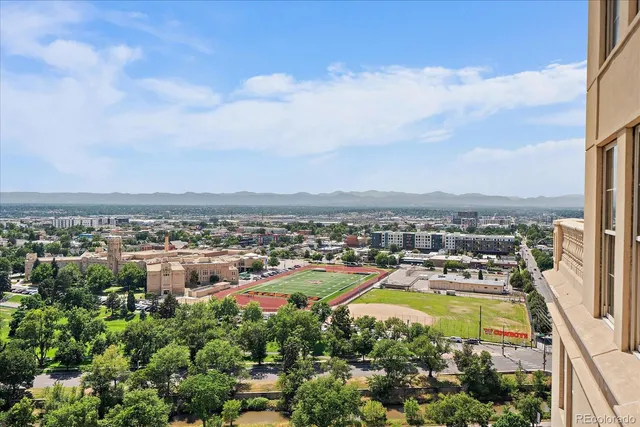 an aerial view of a residential houses with city view